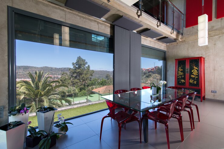 glass dining table with red methacrylate chairs interior modern house with orchids double height concrete house overlooking countryside 136960 160